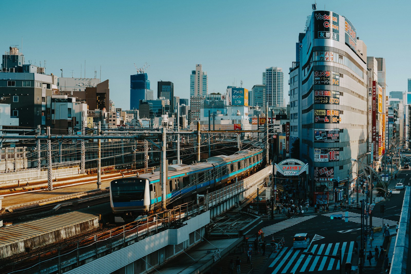 A train travels through a bustling city.